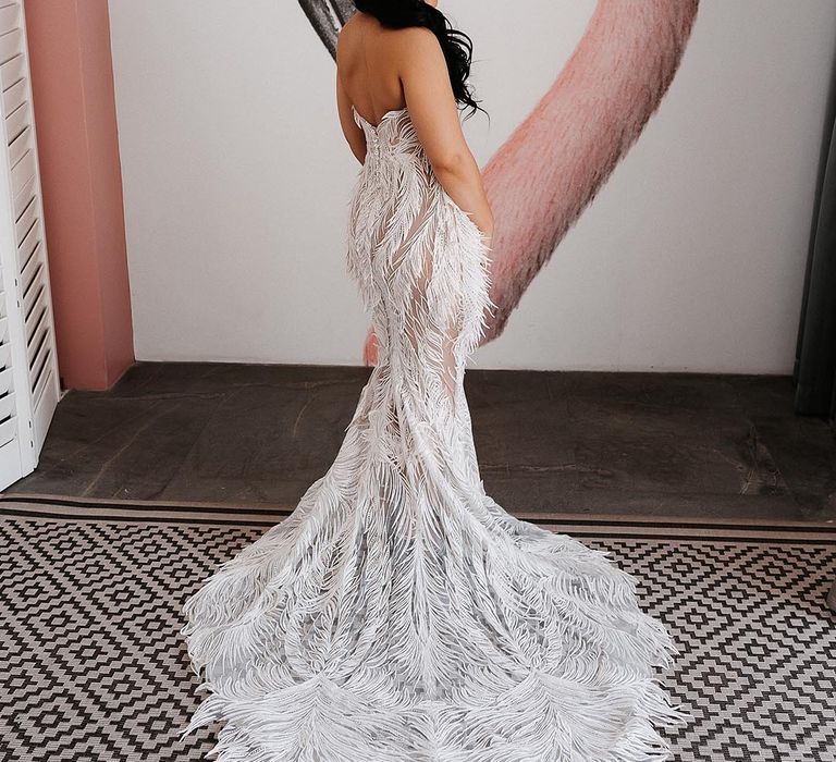 Bride in a feathered fitted lace wedding dress 