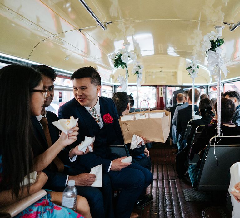 Wedding guests gather in London bus after wedding ceremony