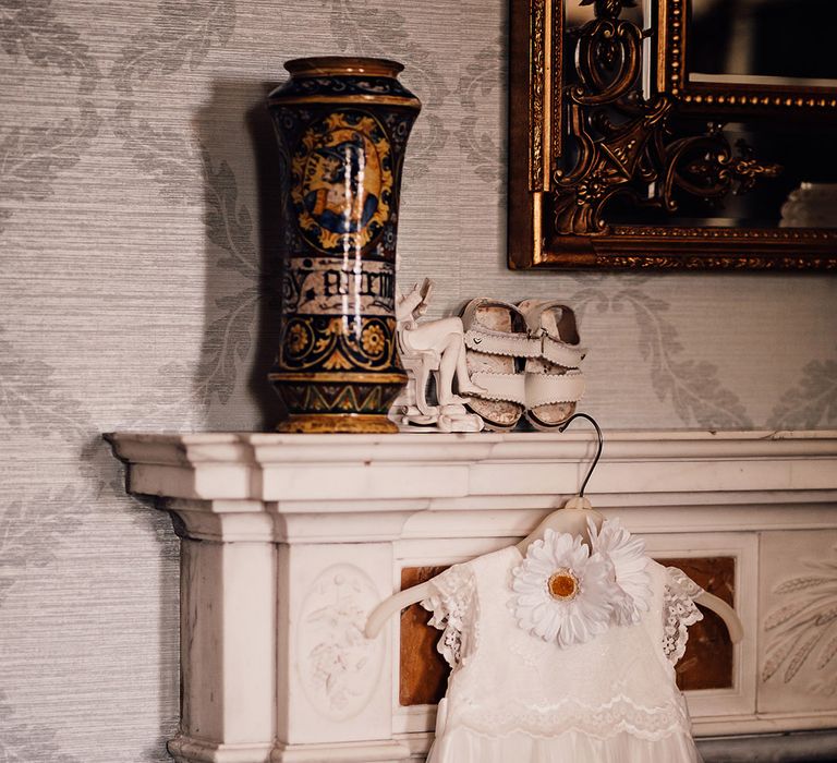 Lace and tulle white flower girl dress with two flowers and tiny baby shoes 