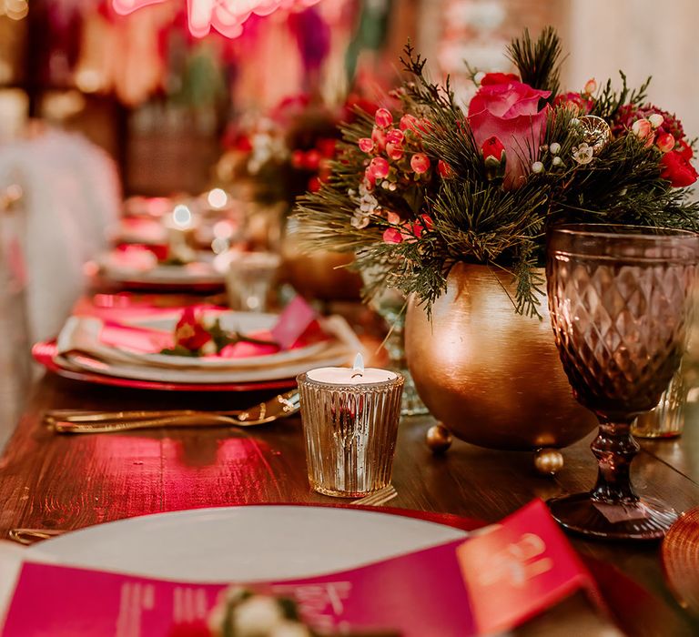 Wedding tablescape with hot pink plates, hot pink place names, gold candleholders and gold vase centrepieces with rose, peony and dried flower floral arrangements 