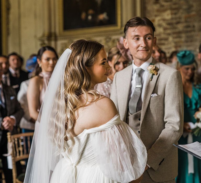 The bride and groom stand facing each other for their civil wedding ceremony at St Giles House 