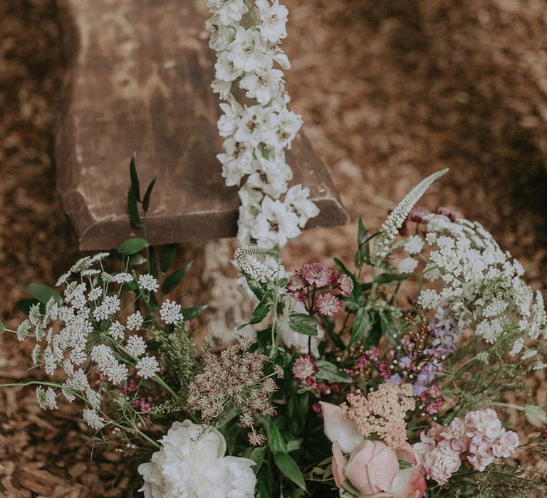 Outdoor wedding with pink and white wildflower aisle decoration 