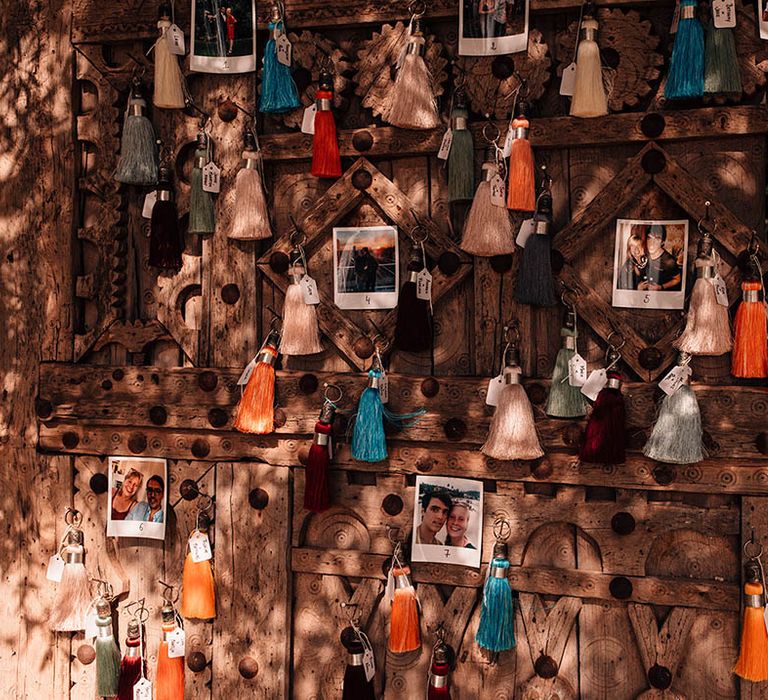 Colourful tassels with polaroid personal pictures decorating the wedding venue 