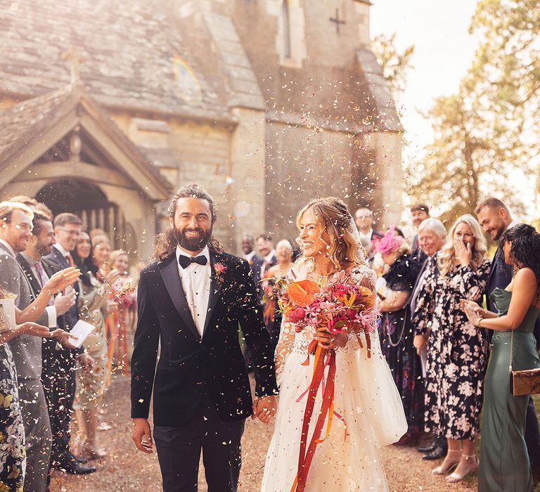 Church wedding for the bride and groom have a confetti exit 