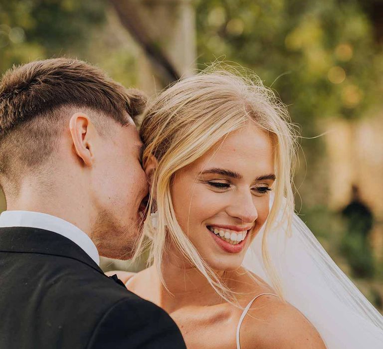 Bride and groom smiling and embracing at Euridge Manor wedding 