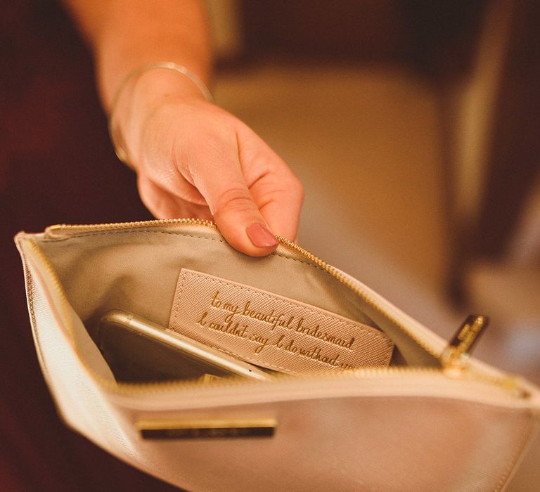 Personalised message inside the bridesmaid's clutch bag for the wedding as a gift 