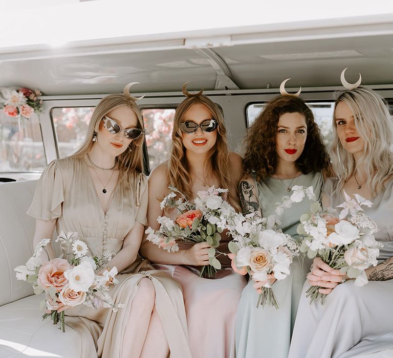 Moon maidens in pastel wedding outfits and crescent moon shaped headbands in vintage campervan 