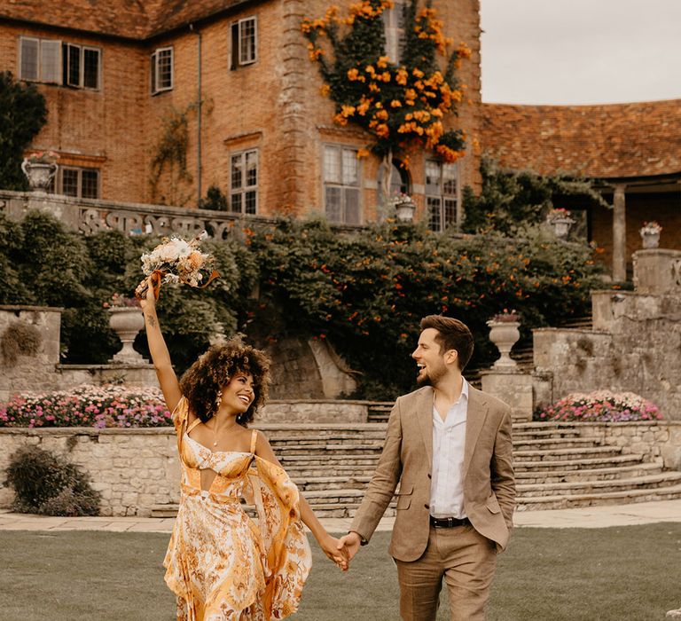 Safari wedding at Port Lympne in Kent with the bride wearing a colourful wedding dress 