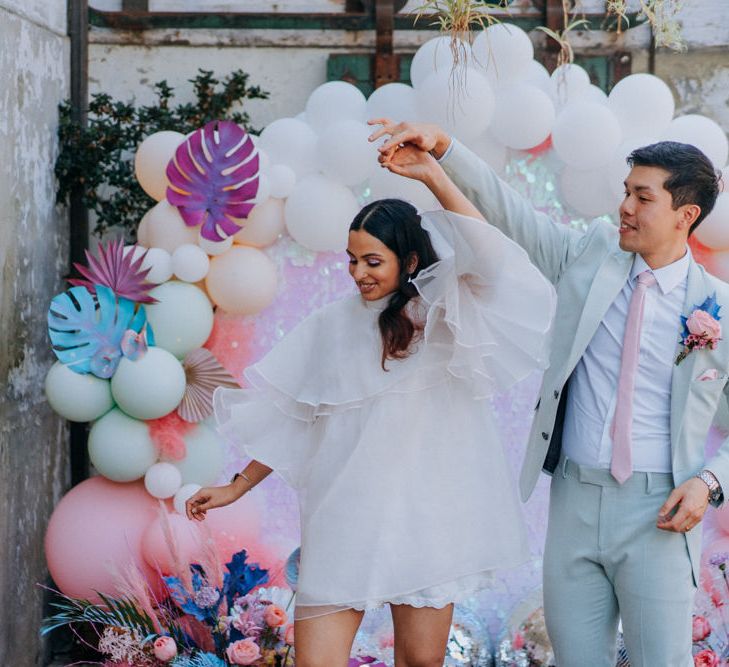 Stylish bride and groom at psychedelic wedding 