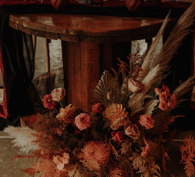 Orange wedding flowers and dried grasses 