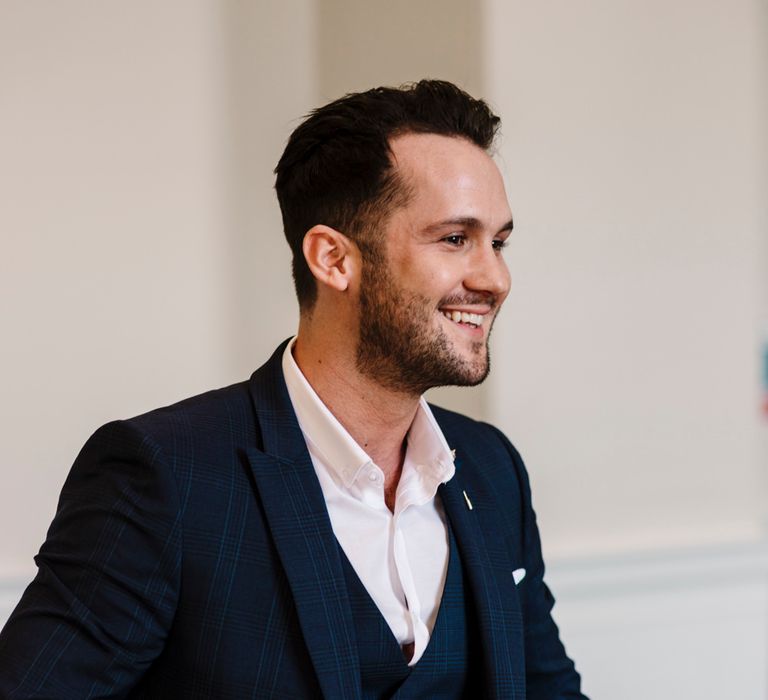 Groom in three-piece navy suit 