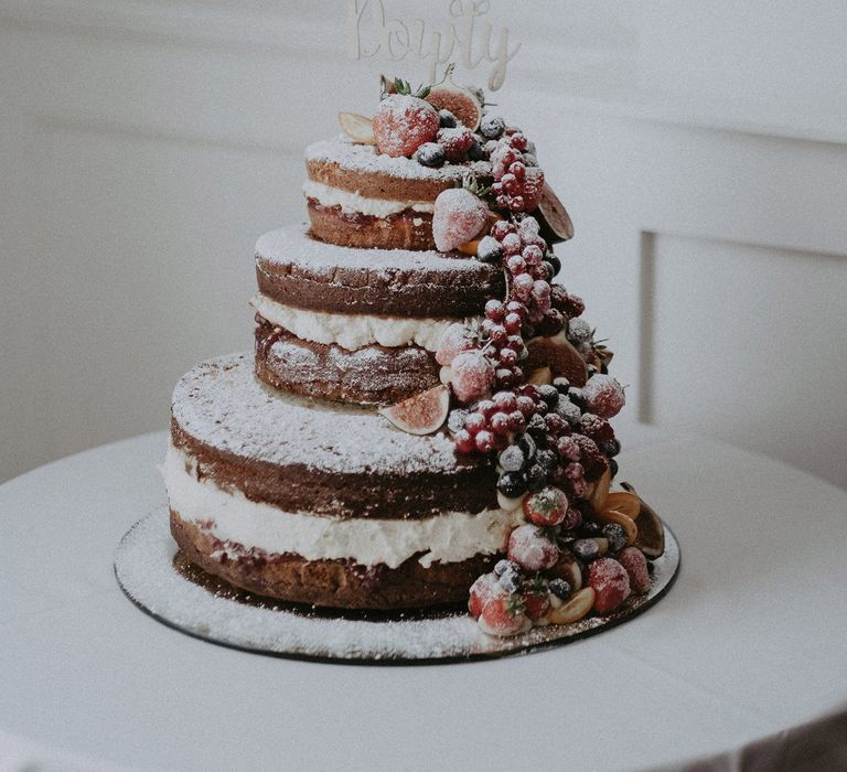 Naked wedding cake decorated with berries