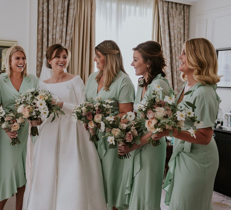 Mint green bridesmaid dresses with pastel bouquet 