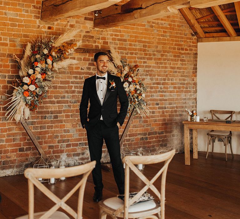 Groom waits for bride at the altar