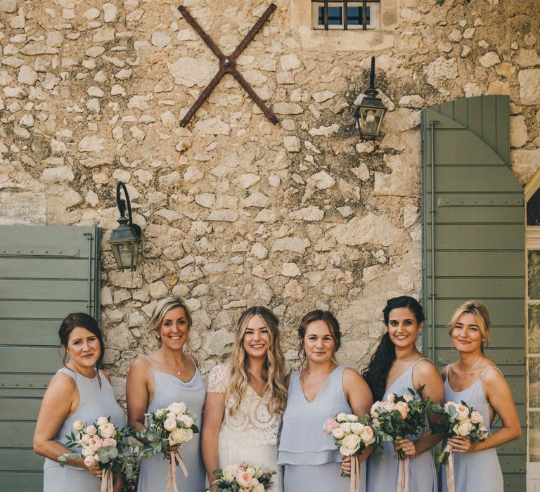 Bridesmaids wearing assorted dressed by Constellation Ame in pale heather blue