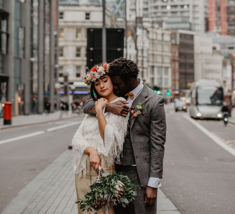 Couple embrace in London wedding photo location with Gherkin building in the background