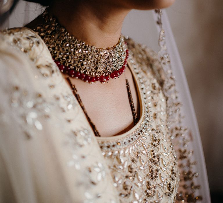 Bride wearing golden two piece and gold necklace 