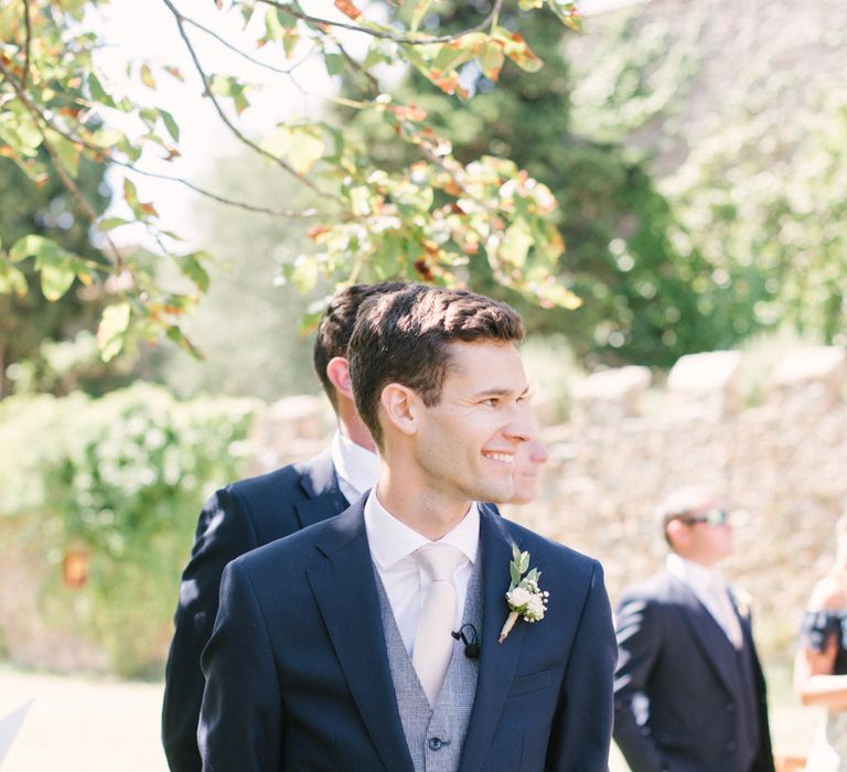 Groom in a navy suit with light blue waistcoat and champagne tie | Hannah Duffy Photography