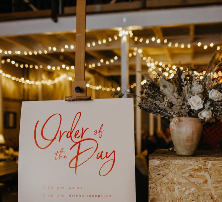 Order of the day sign on easel with red writing