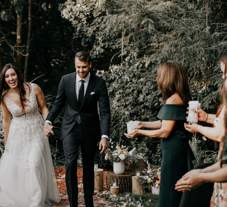 Bride & groom hold hands during New York elopement after wedding ceremony 