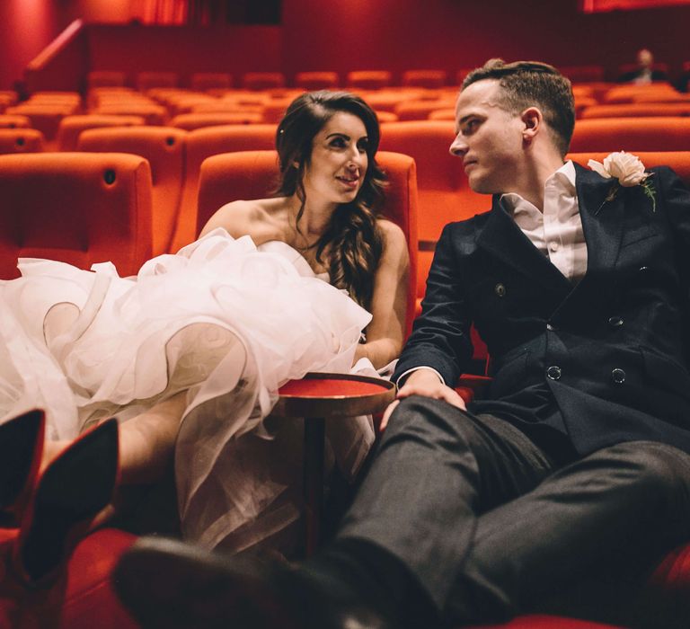 Bride and groom at Olympic studios cinema in Barnes on their wedding day