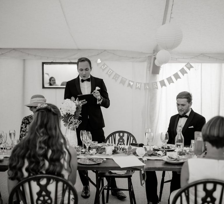 Wedding party during reception listening to speeches