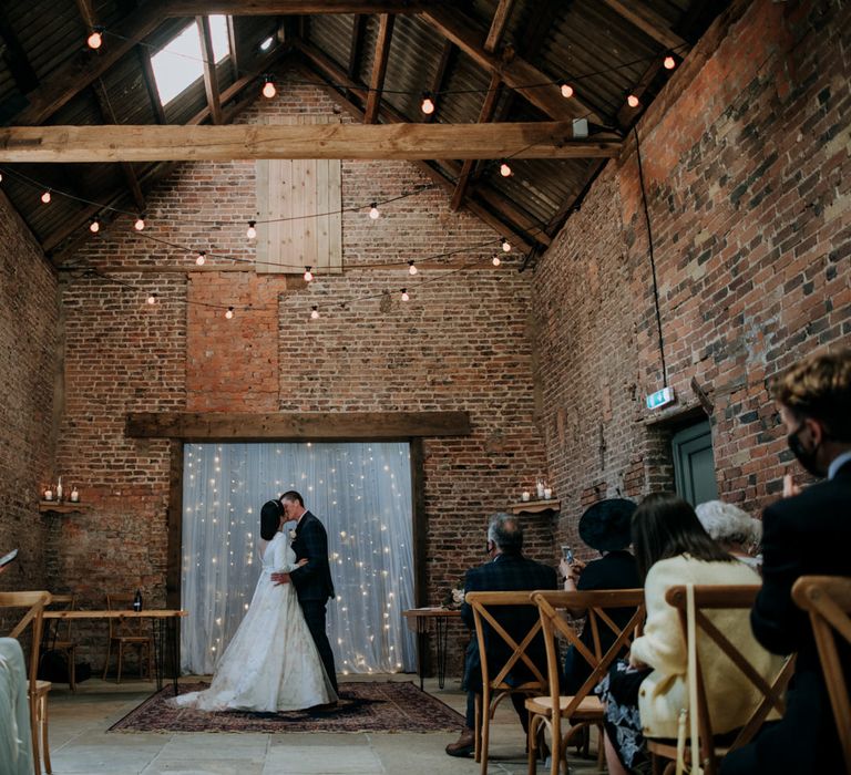 Intimate wedding ceremony at East Yorkshire Barns with Festoon lights and fairy lights wedding decor 