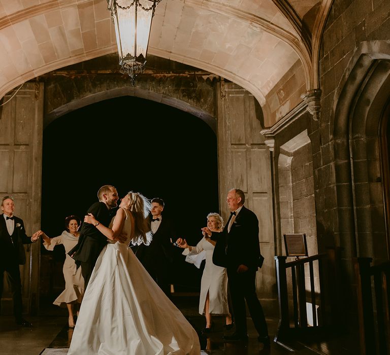 Bride & groom dance outdoors for first dance moment under arch at Markree Castle