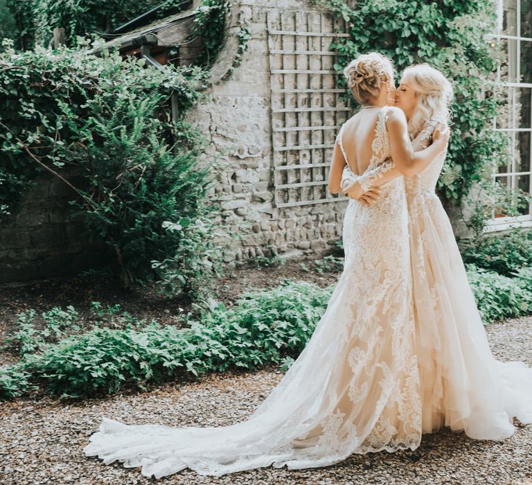 Two brides embrace after a 'first look' before their wedding ceremony at Crab and Lobster Fairytale Wedding.