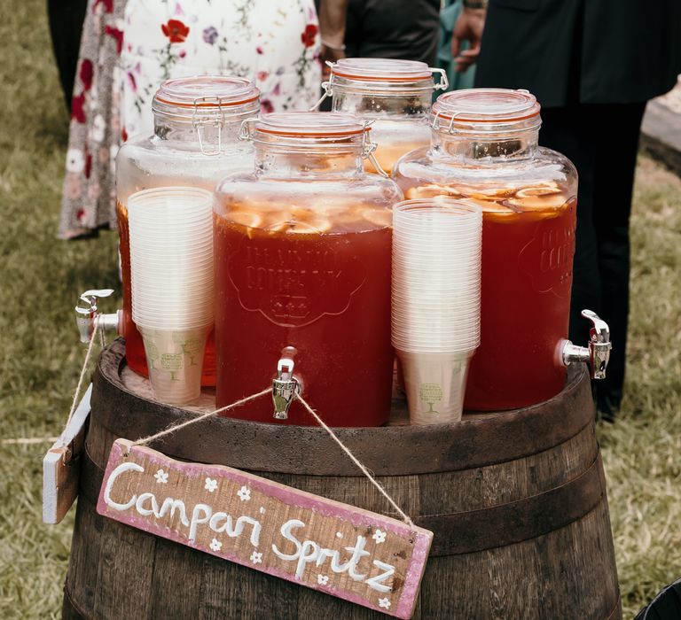 Cocktails served for reception with DIY sign on barrel outdoors