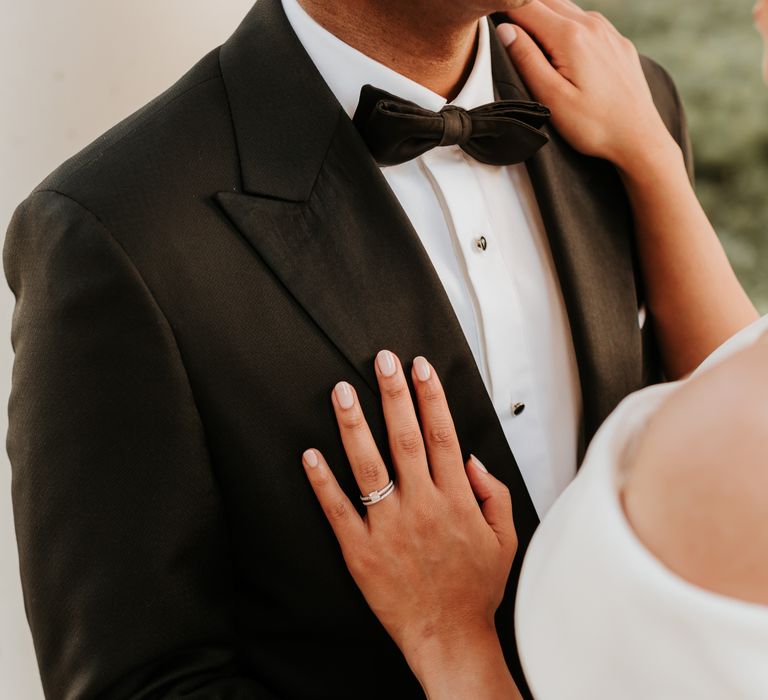 Bride places her hand on grooms dinner jacket after wedding ceremony | Hannah MacGregor Photo & Film