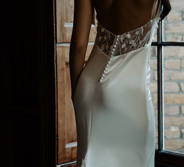 Satin slip Constellation Ame wedding dress with love back, buttons and lace detail 