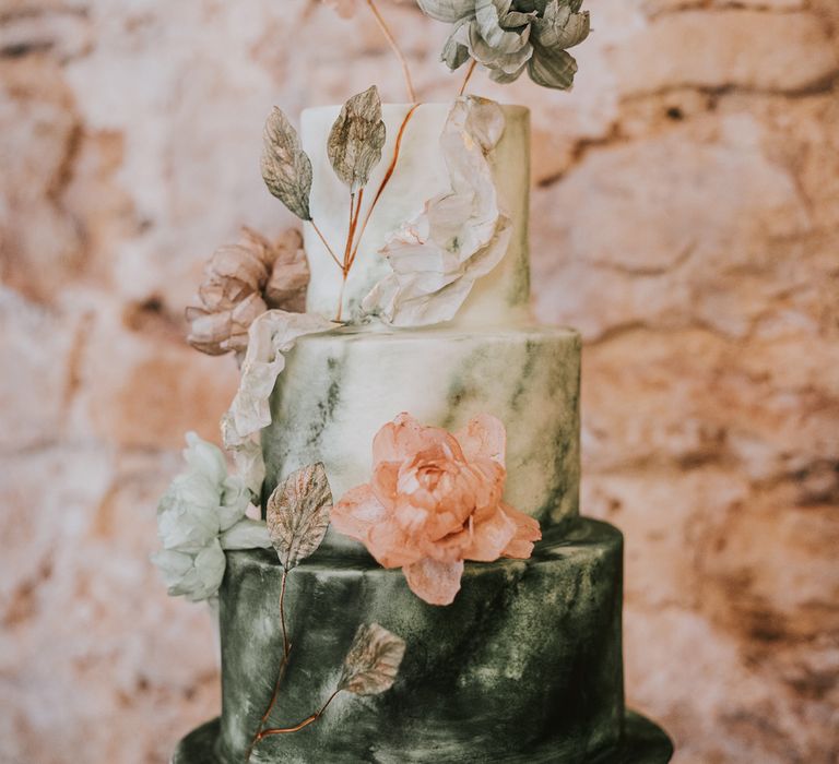 White and green three tier wedding cake by Cherry Tree Cakerie with peach and green floral decor