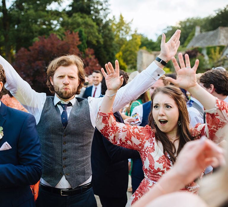 Wedding guests enjoying the surprise first dance performed by the bride and groom 