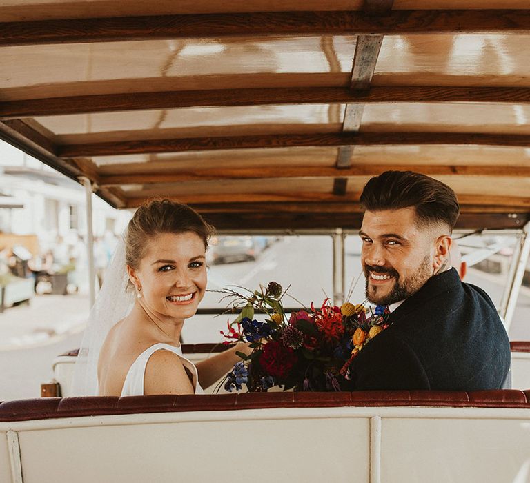 Bride and groom in their Tuc Tuc wedding transport 