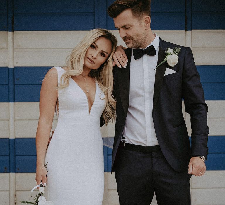 Plunge wedding dress with white bouquet for bride