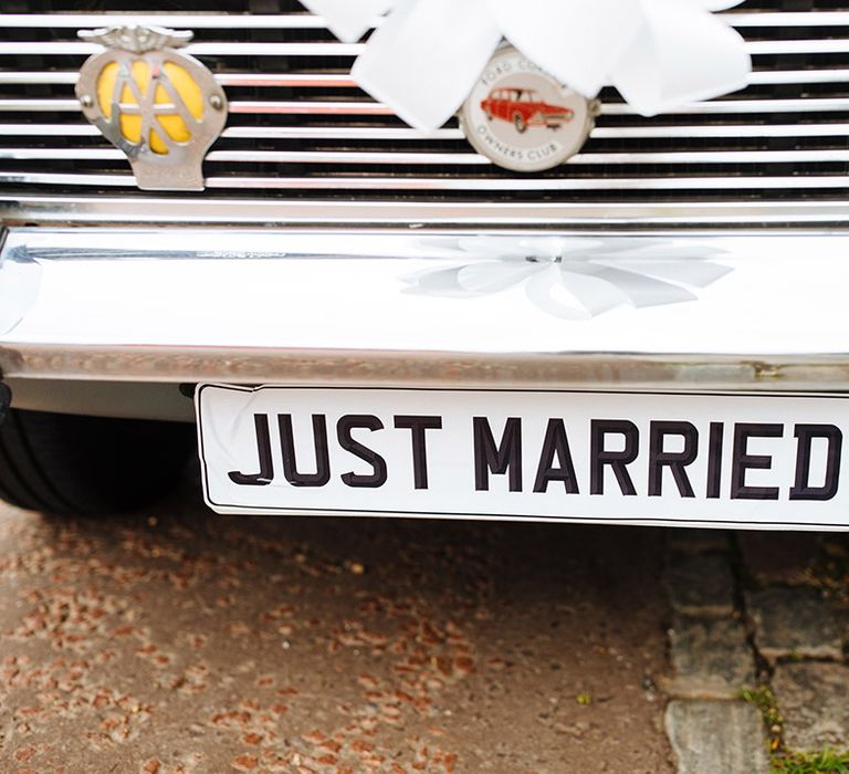 Vintage baby blue wedding car transportation with 'Just Married' number plate 