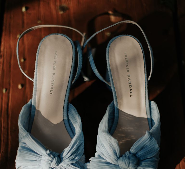 Blue bow Loeffler Randall wedding shoes with wedding rings and bands 