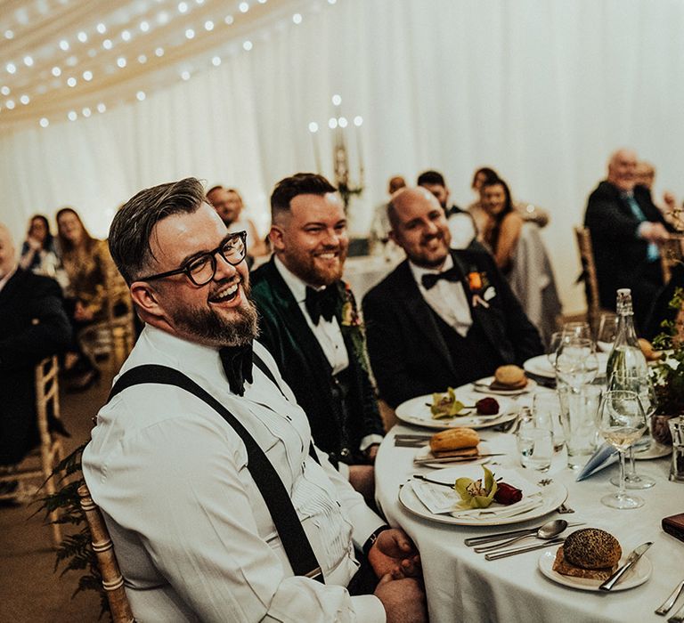 Guests under the fairy lit venue for wedding reception