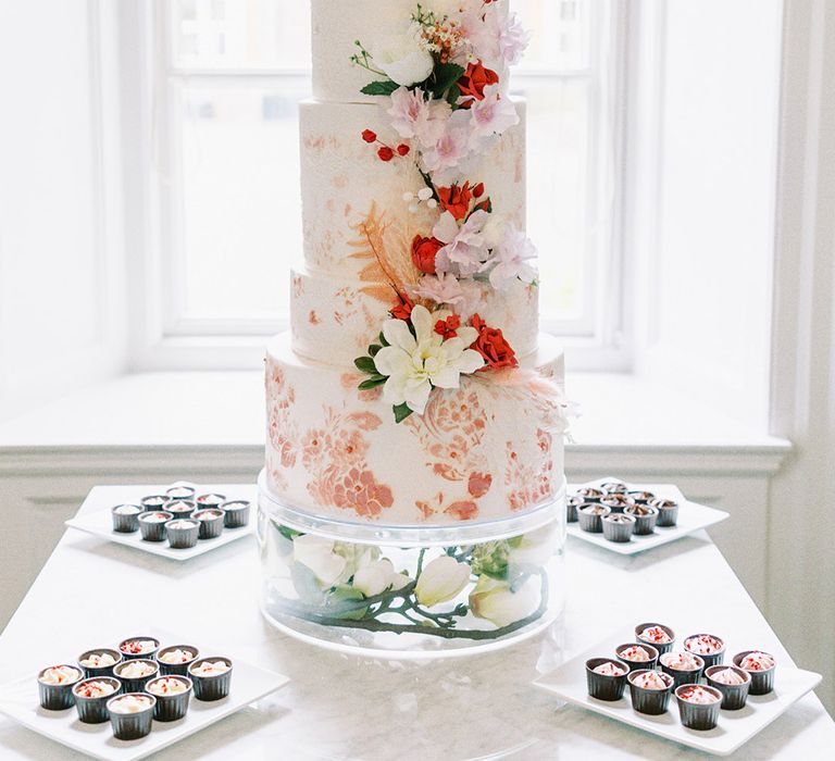 five tier wedding cake with floral design and flower decor 