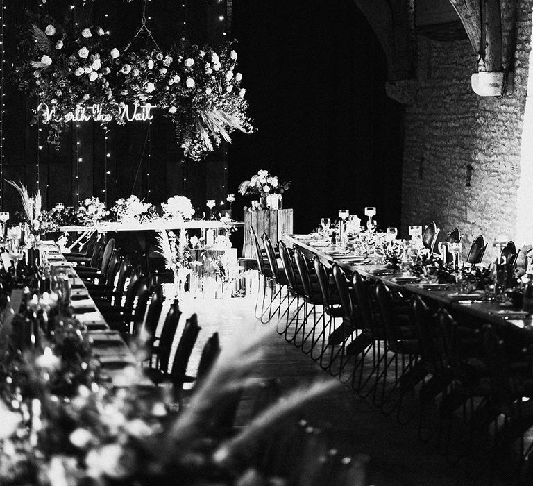 Tythe Barn wedding venue for the reception with fairy lights, neon sign, dried flowers and a flower cloud 