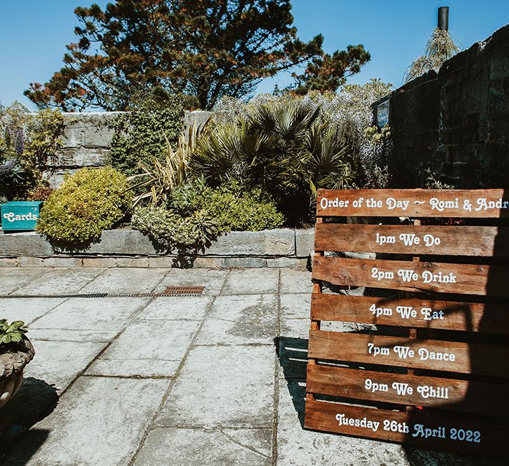 DIY Order Of The Day wooden pallet stands outdoors for Cornish wedding day 