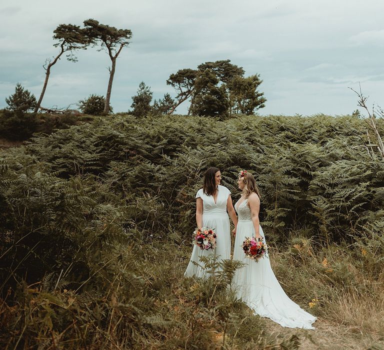 Cute couple portrait of the two brides on their day of their festive style tipi wedding 