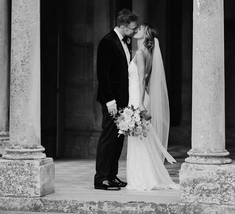 The bride and groom lean in for a kiss together as they share some special intimate moments together for their couple portraits 