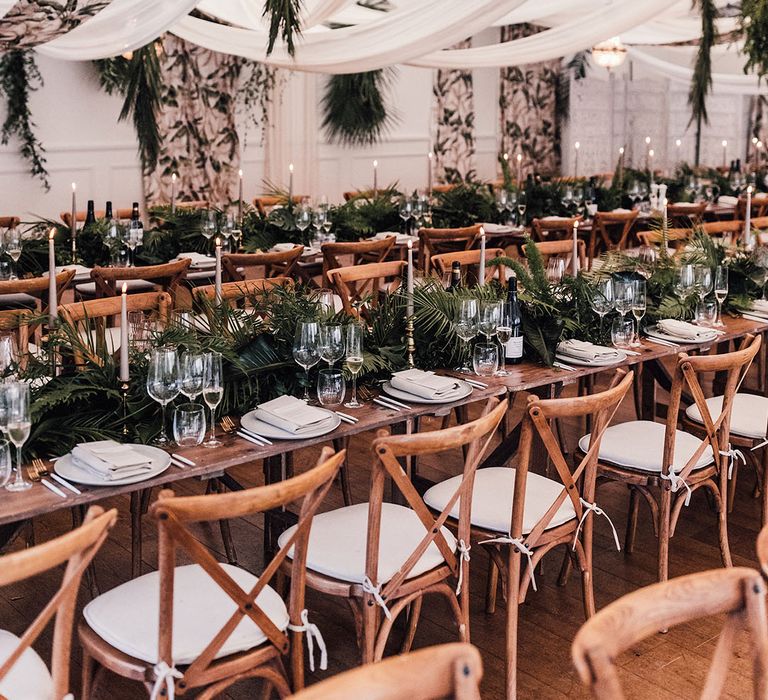 Botanical greenery theme wedding with leafy flower arrangements on the table and hanging installations for marquee wedding 