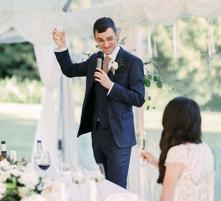 Grooms wedding speech in a navy blue wedding suit 