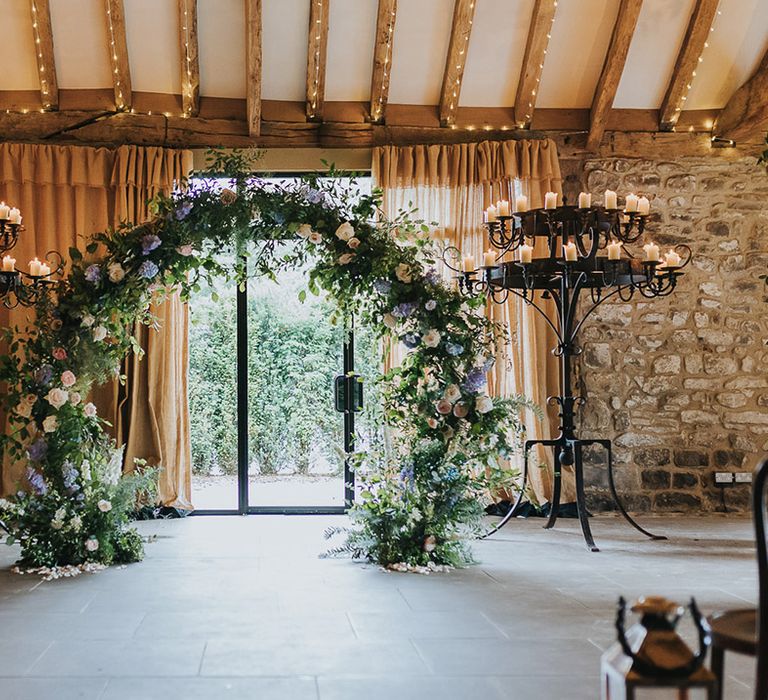 wedding ceremony floral moon gate and candle altar wedding decor at Tithe Barn Bolton Abbey