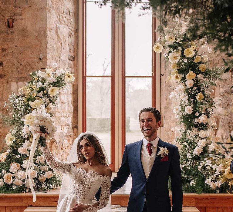 Bride and groom walk back down the aisle as a married couple after their civil ceremony 