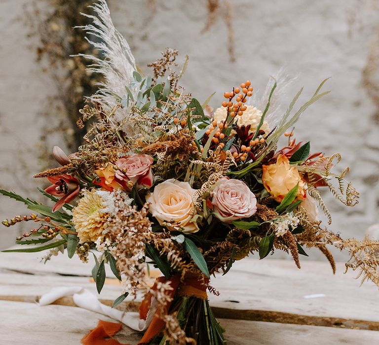 Autumnal wedding bouquet with roses for the rustic wedding 