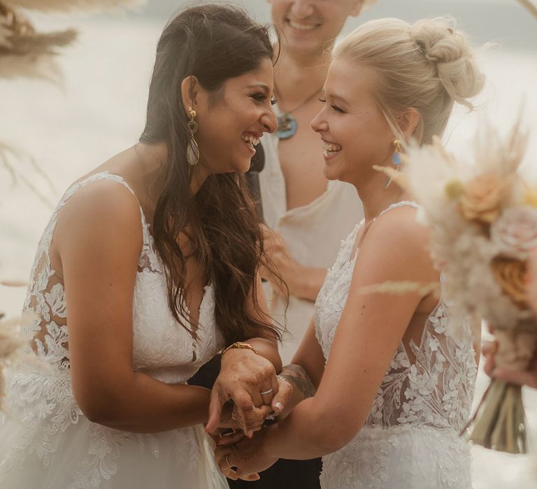 Indian bride and Swiss bride laughing during their celebrant-led ceremony at their Croatia destination wedding 